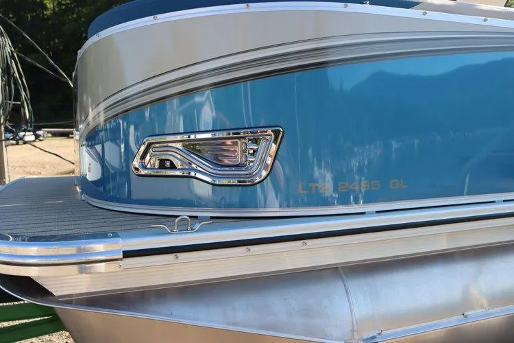 Slide: The Image of 2022 Tahoe Pontoon LTZ 2485 QL, blue exterior detail with chrome accents. - 11