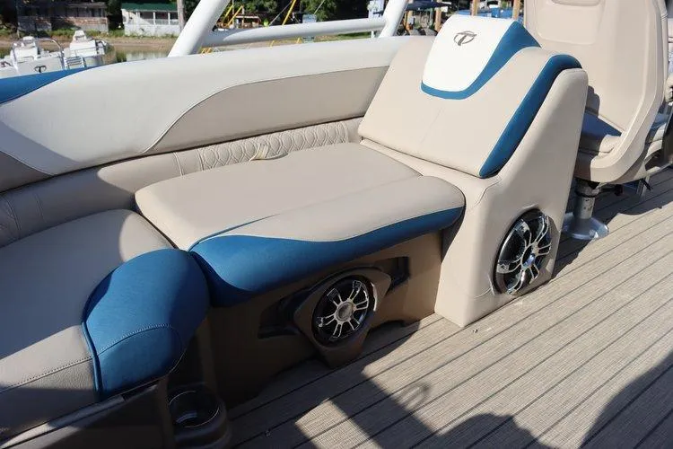 Slide: The Image of 2022 Tahoe Pontoon LTZ 2485 QL interior seating with built-in speakers. - 17