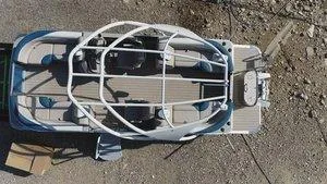 Slide: The Image of 2022 Tahoe Pontoon LTZ 2485 QL boat, aerial view, docked on gravel. - 18