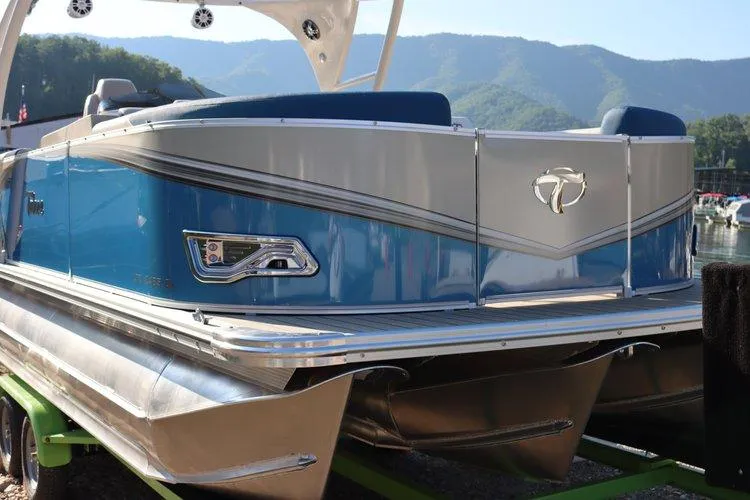 Slide: The Image of 2022 Tahoe Pontoon LTZ 2485 QL boat docked with scenic mountain backdrop. - 3