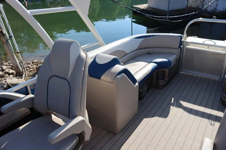 Slide: The Image of 2022 Tahoe Pontoon LTZ 2485 QL interior seating area with lake view. - 7