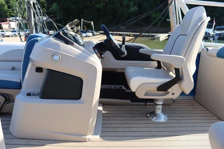 Slide: The Image of 2022 Tahoe Pontoon LTZ 2485 QL helm station with captain's chair and steering wheel. - 8