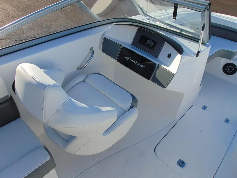Slide: The Image of 2024 Hurricane SunDeck 191 OB boat interior with white captain's seat and dashboard. - 4
