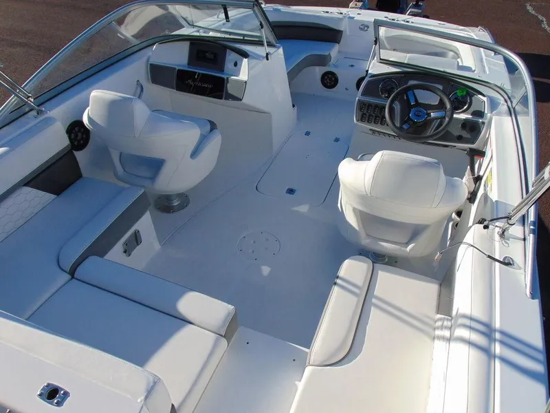 Slide: The Image of 2024 Hurricane SunDeck 191 OB boat interior with white seating and modern dashboard. - 5