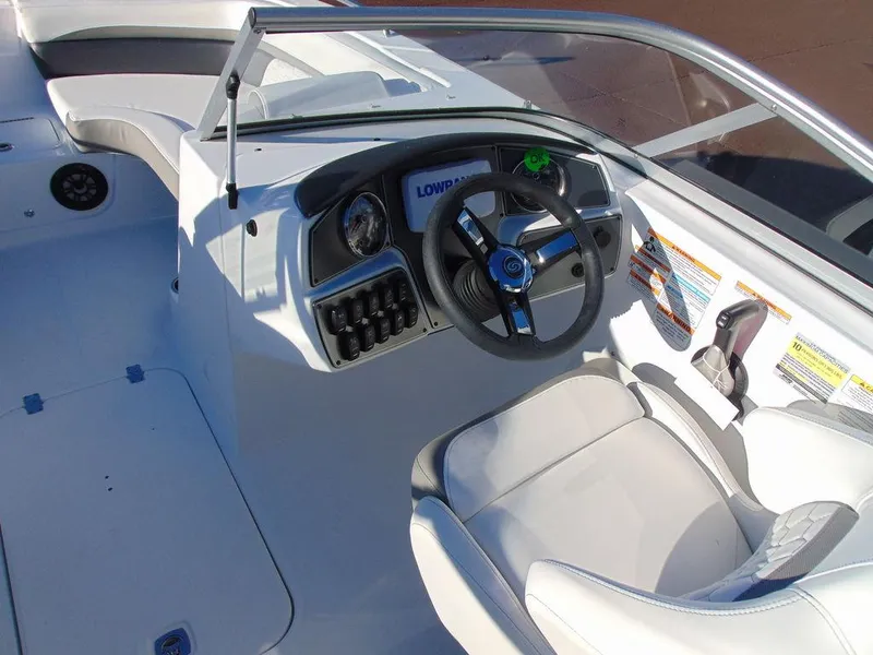 Slide: The Image of 2024 Hurricane SunDeck 191 OB boat cockpit with steering wheel and control panel. - 6