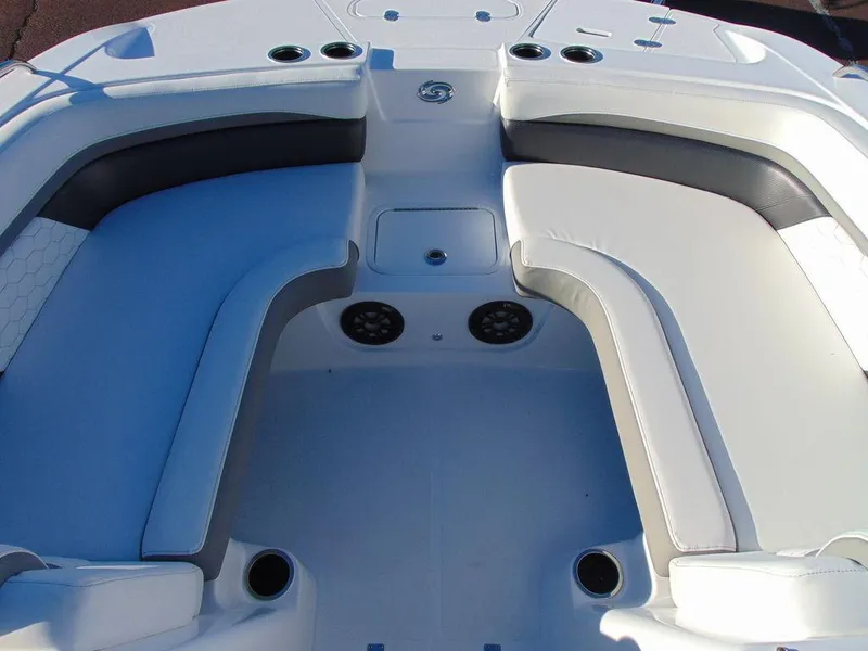 Slide: The Image of 2024 Hurricane SunDeck 191 OB boat interior with cushioned seating and cup holders. - 9