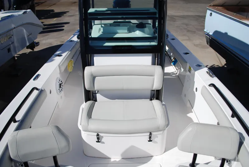 Slide: The Image of 2021 Everglades 253 boat interior with cushioned seating and storage. - 12
