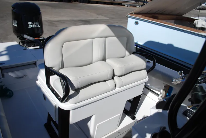 Slide: The Image of Everglades 253 boat 2021 model with cushioned seating and outboard motor. - 14