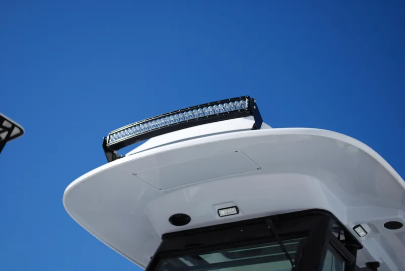 Slide: The Image of Close-up of 2021 Everglades 253 boat's roof and light bar against blue sky. - 2