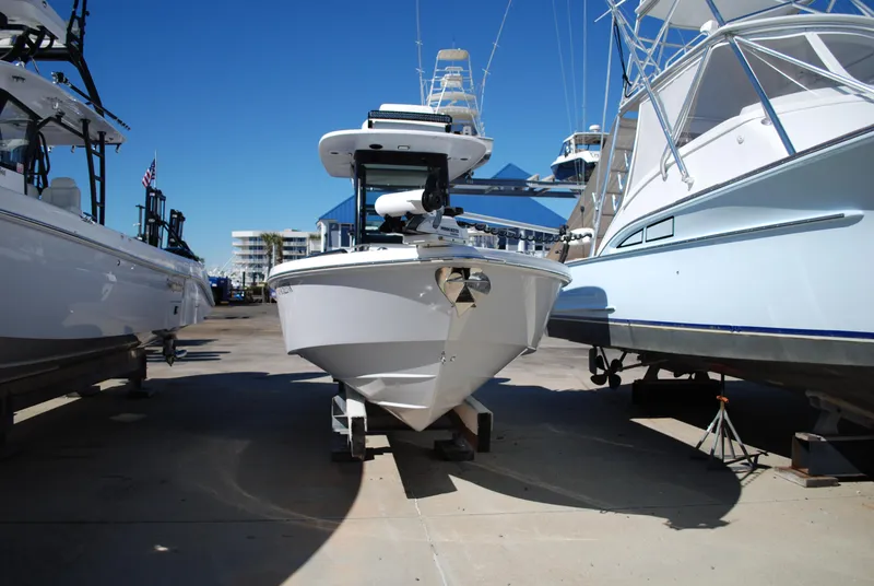 Slide: The Image of 2021 Everglades 253 boat docked between other boats in a marina. - 5