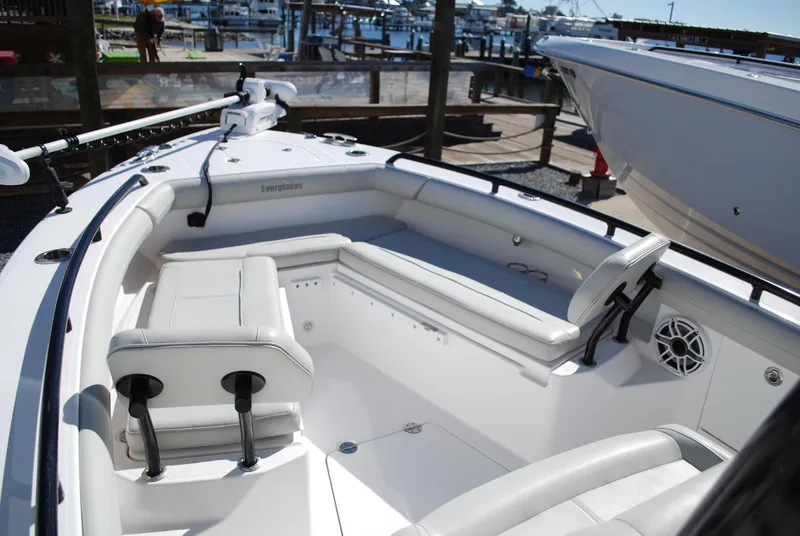 Slide: The Image of 2021 Everglades 253 boat interior with white seating and docked marina background. - 9