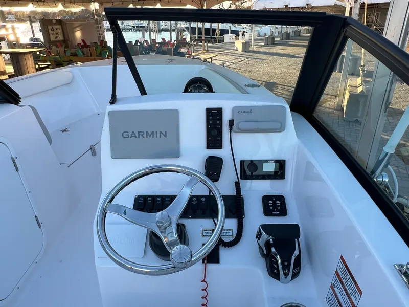 Slide: The Image of 2024 Aquasport 2200 DC boat dashboard with Garmin navigation system. - 10