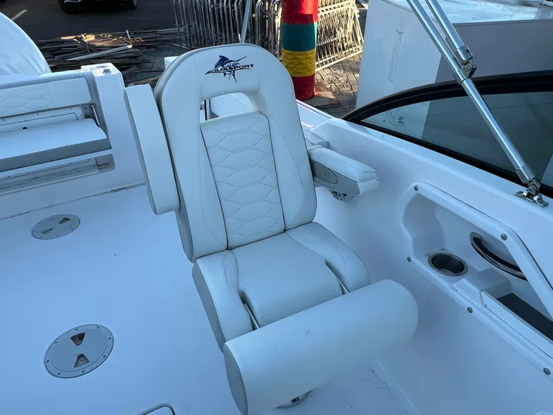 Slide: The Image of 2024 Aquasport 2200 DC boat interior with white seating and modern design. - 11