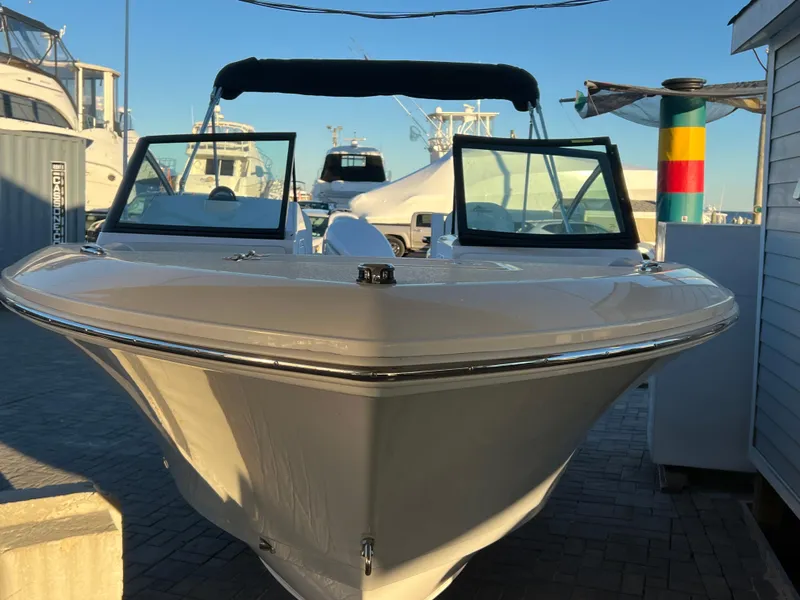 Slide: The Image of 2024 Aquasport 2200 DC boat docked at marina, front view. - 4