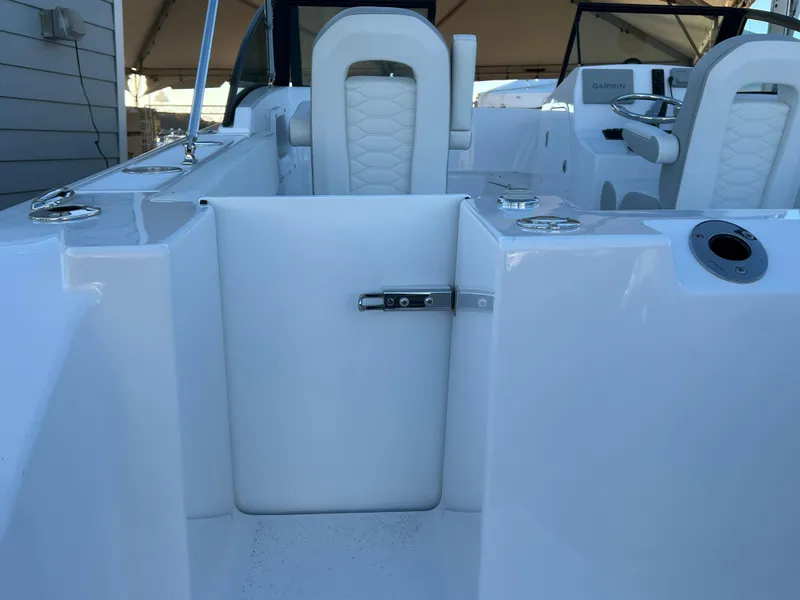 Slide: The Image of 2024 Aquasport 2200 DC boat interior with white seating and sleek design. - 7