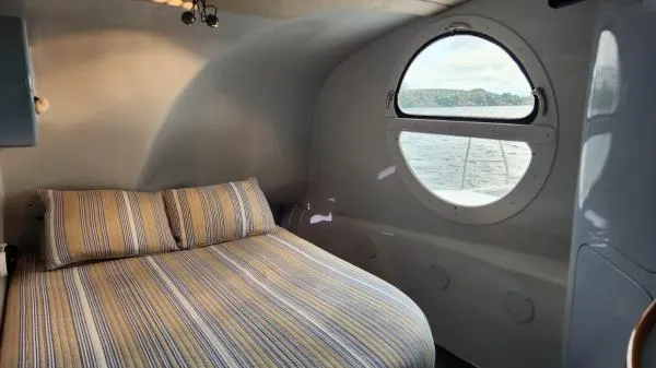Slide: The Image of Cozy bedroom in 1991 Custom Morelli-Miller boat with round window and striped bedding. - 10