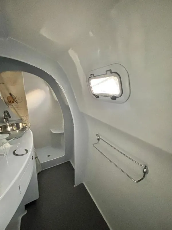 Slide: The Image of Compact bathroom interior of 1991 Custom Morelli-Miller with porthole window and stainless steel sink. - 11