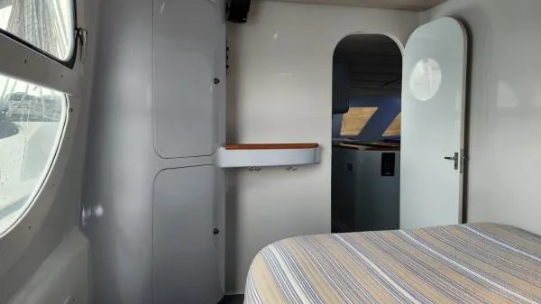 Slide: The Image of Interior of 1991 Custom Morelli-Miller boat with bed, cabinets, and open door. - 13