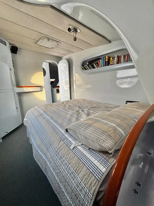 Slide: The Image of Interior of a 1991 Custom Morelli-Miller with bed, bookshelves, and modern design. - 20