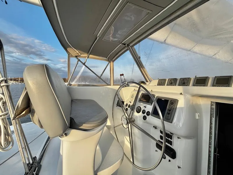 Slide: The Image of Interior of 1991 Custom Morelli-Miller boat cockpit with steering wheel and navigation instruments. - 26