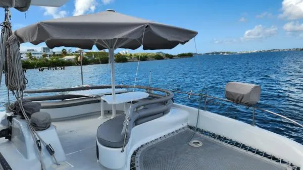 Slide: The Image of Deck of 1991 Custom Morelli-Miller boat with umbrella, overlooking serene blue waters. - 28
