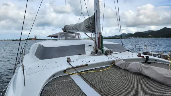 Slide: The Image of Sailing yacht on water, Custom Morelli-Miller 1991, with cloudy sky and distant mountains. - 32