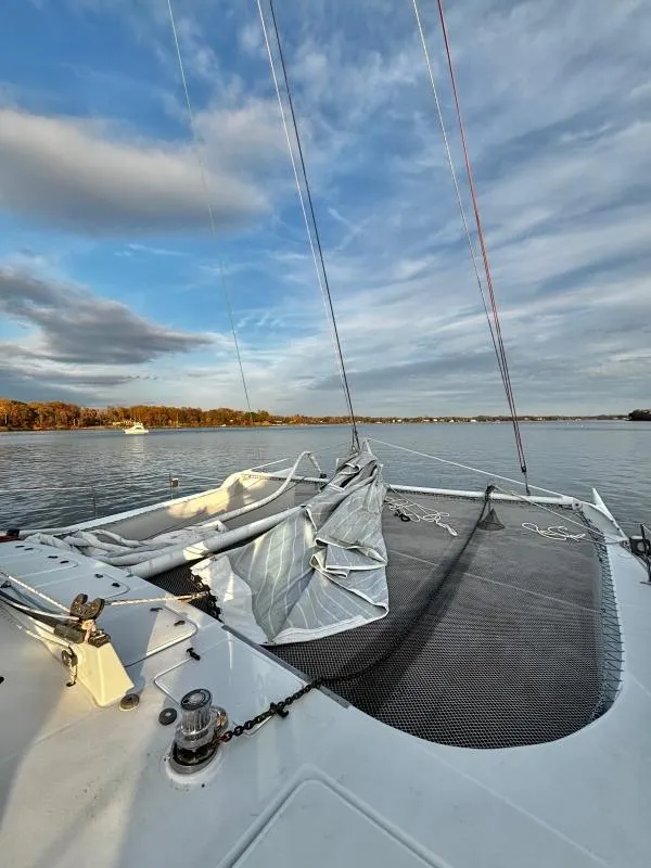 Slide: The Image of Sailboat deck view on calm water, Custom Morelli-Miller 1991, under a partly cloudy sky. - 36