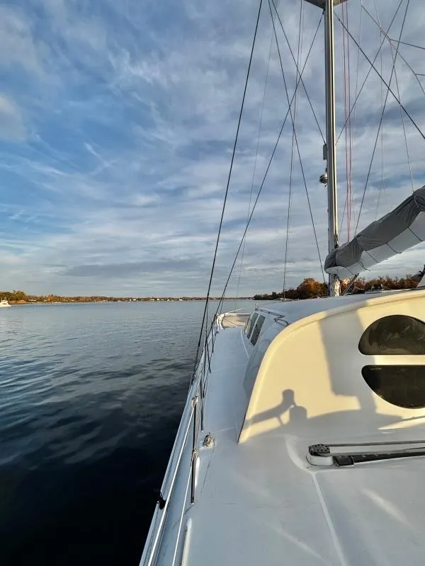Slide: The Image of Sailboat on calm water, Custom Morelli-Miller 1991, under a partly cloudy sky. - 40