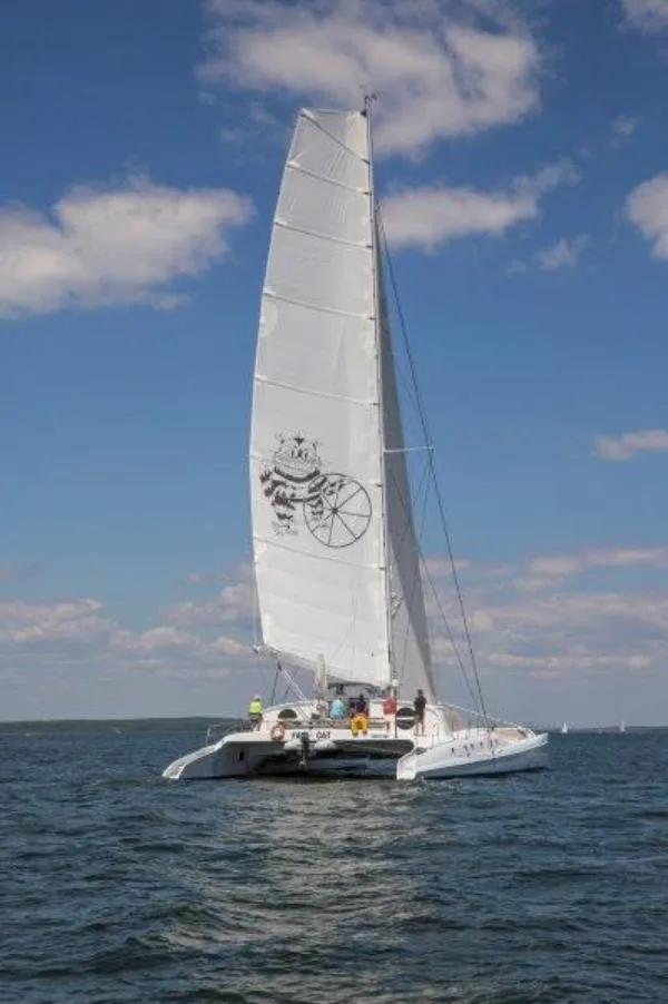 Slide: The Image of Sailing catamaran "Morelli-Miller" 1991 on open water under a clear blue sky. - 43