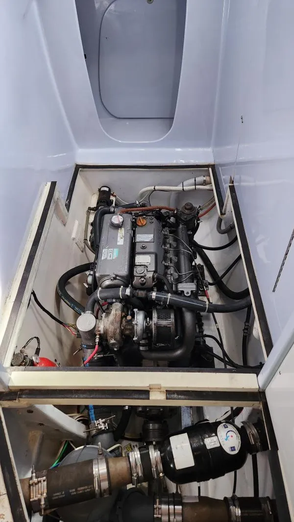 Slide: The Image of Engine compartment of a 1991 Custom Morelli-Miller, showcasing detailed mechanical components. - 47