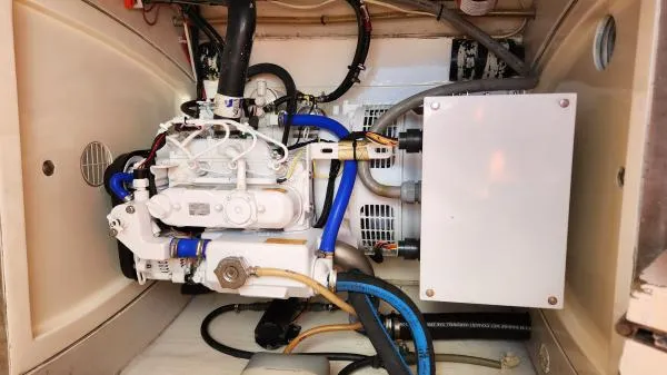 Slide: The Image of Engine compartment of a 1991 Custom Morelli-Miller, featuring various hoses and components. - 48