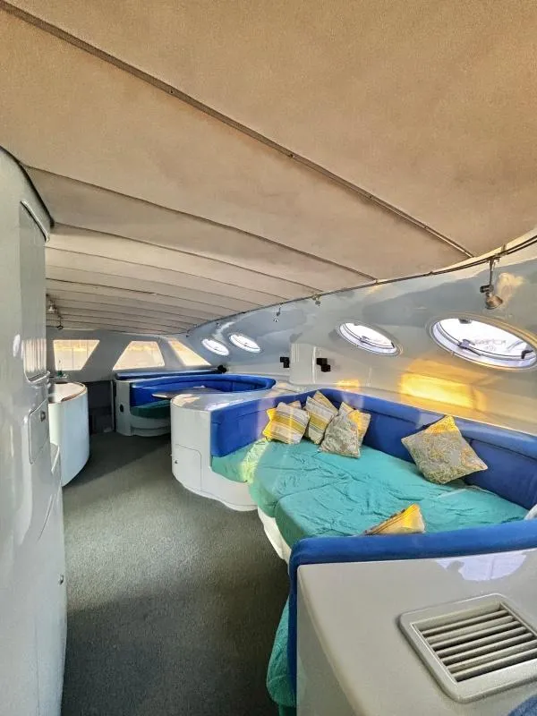 Slide: The Image of Luxurious interior of 1991 Custom Morelli-Miller yacht with cozy seating and stylish decor. - 6