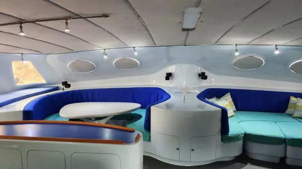 Slide: The Image of Luxurious 1991 Custom Morelli-Miller yacht interior with blue seating and modern design. - 7
