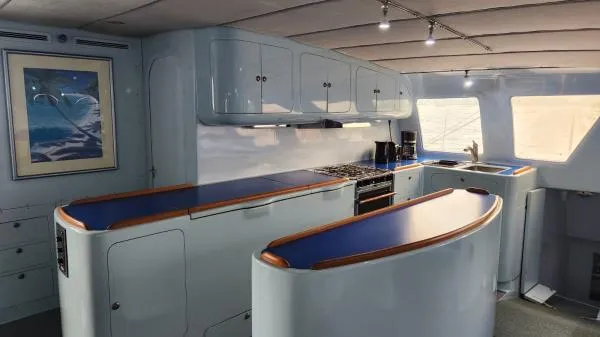 Slide: The Image of Spacious 1991 Custom Morelli-Miller yacht kitchen with modern design and blue countertops. - 8