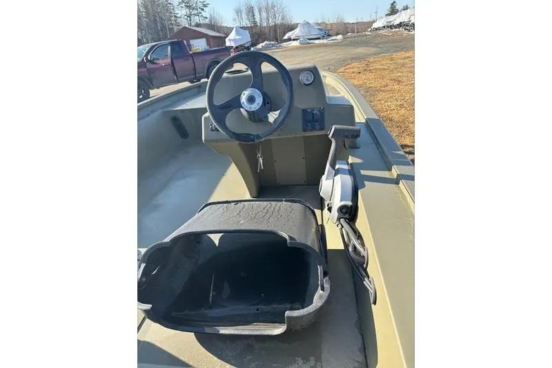 Slide: The Image of 2024 Tracker Grizzly 1754 SC boat interior with steering wheel and control panel. - 3