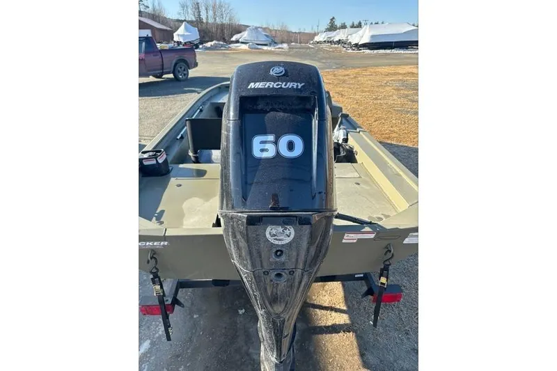 Slide: The Image of 2024 Tracker Grizzly 1754 SC boat with Mercury 60 horsepower engine, parked outdoors. - 5