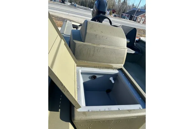 Slide: The Image of 2024 Tracker Grizzly 1754 SC boat with open storage compartment, outdoor setting. - 6