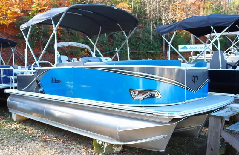 Slide: The Image of 2023 Tahoe Pontoon LT - 21' boat with blue exterior and canopy. - 2