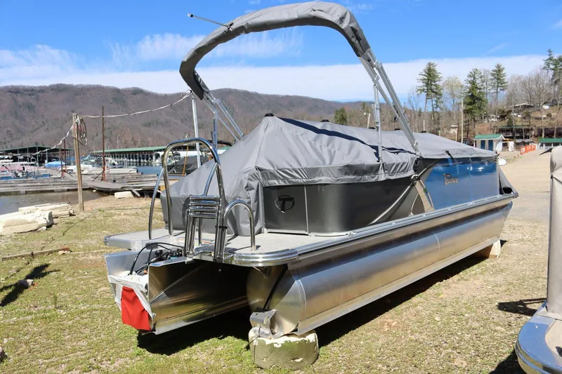 Slide: The Image of 2023 Tahoe Pontoon LT - 21' boat docked on shore with cover. - 6