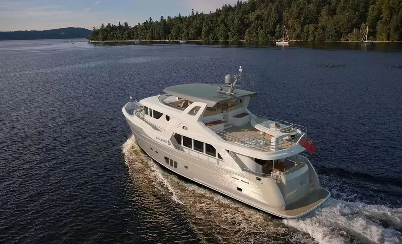 Slide: The Image of Luxurious 2026 Selene 78 Ocean Explorer yacht cruising on a serene lake. - 3