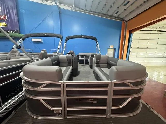 Slide: The Image of 2024 Bennington 188 SVL pontoon boat with gray seating in showroom. - 10