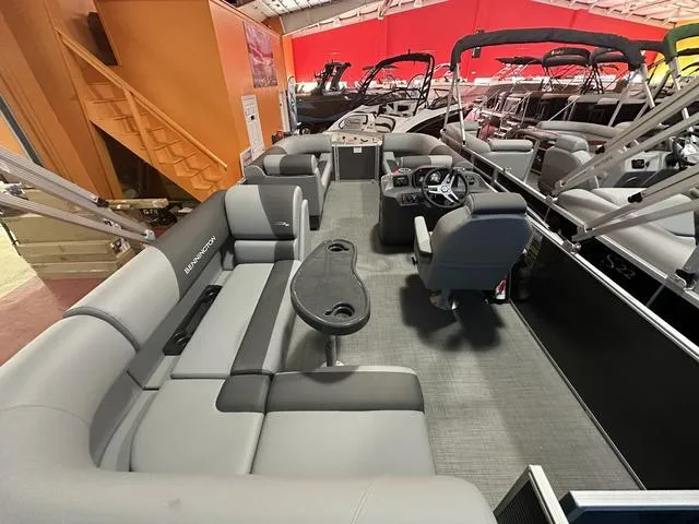 Slide: The Image of 2024 Bennington 188 SVL pontoon boat interior with gray seating and steering console. - 3
