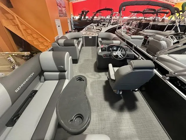 Slide: The Image of 2024 Bennington 188 SVL pontoon boat interior with gray seating and steering console. - 5