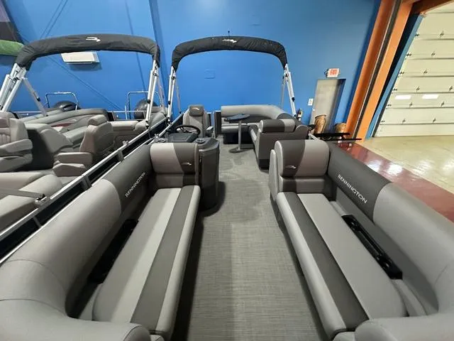 Slide: The Image of 2024 Bennington 188 SVL pontoon boat interior with gray seating and blue walls. - 9