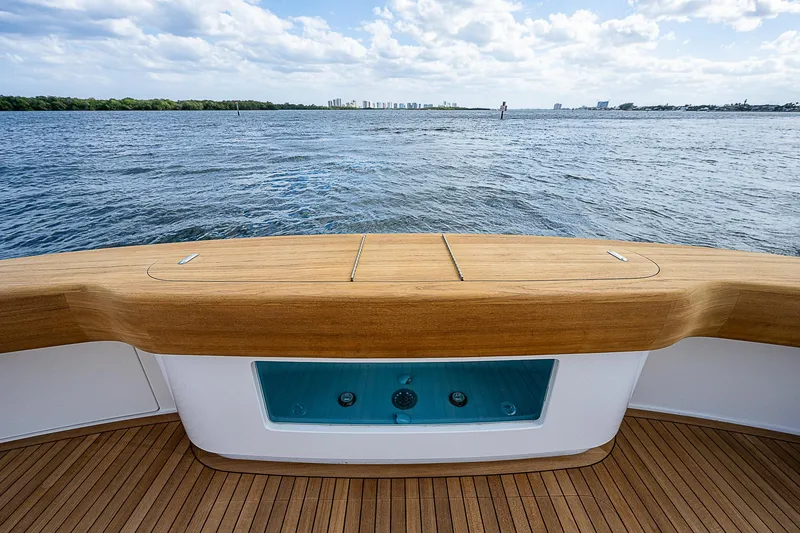 Slide: The Image of Stern view of 2020 Viking 68 Convertible yacht with teak deck and ocean backdrop. - 10