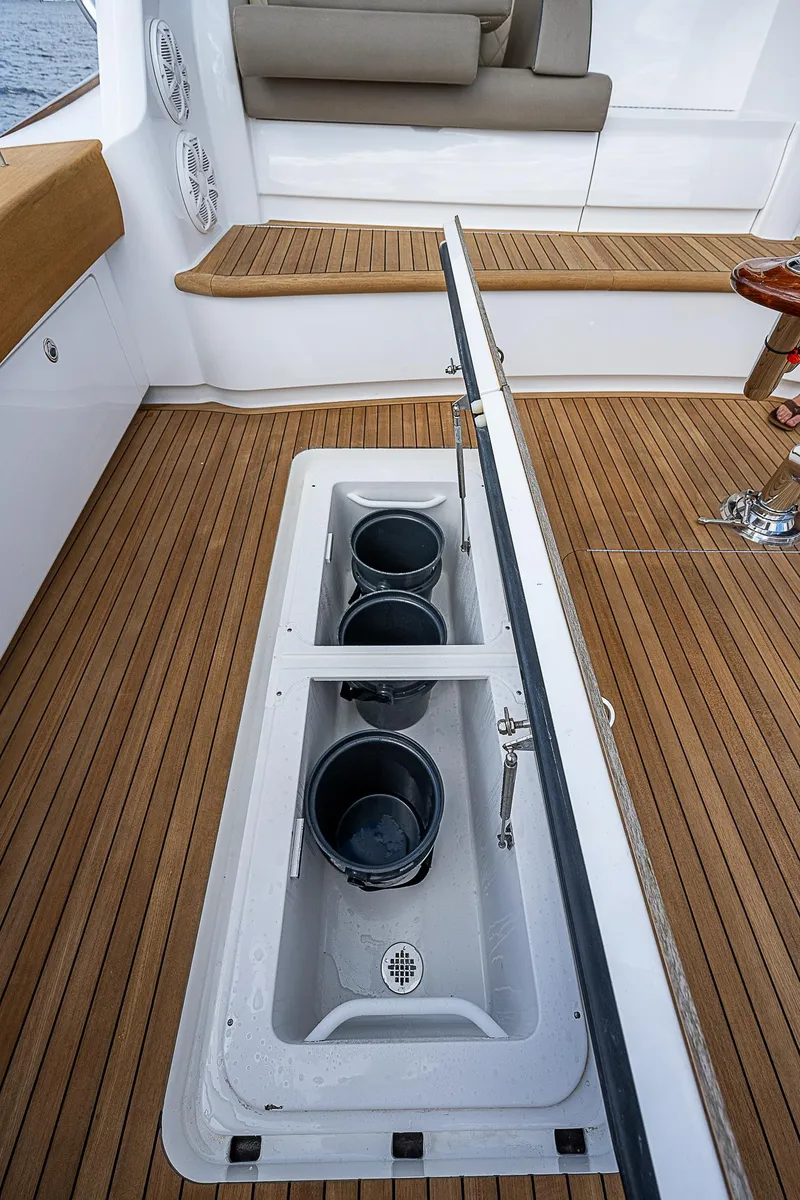 Slide: The Image of 2020 Viking 68 Convertible yacht deck with built-in storage compartments. - 11