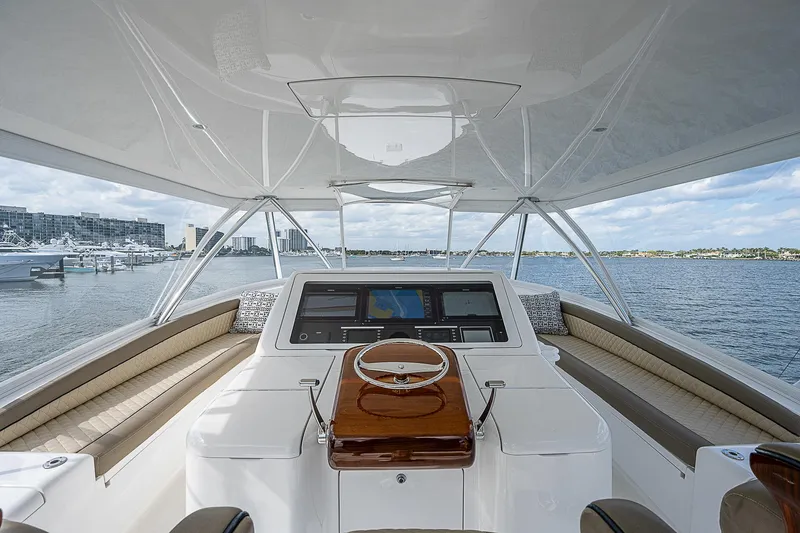Slide: The Image of 2020 Viking 68 Convertible yacht helm station with panoramic water view. - 14