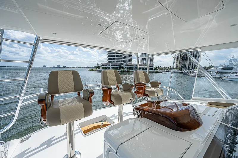 Slide: The Image of Luxurious helm station on a 2020 Viking 68 Convertible yacht with waterfront view. - 15