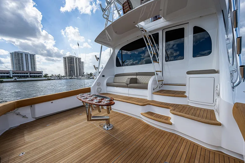 Slide: The Image of 2020 Viking 68 Convertible yacht deck with seating and waterfront view. - 2
