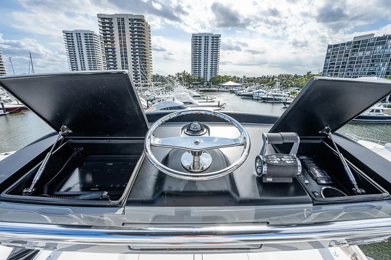 Slide: The Image of Control console of a 2020 Viking 68 Convertible yacht in a marina. - 26